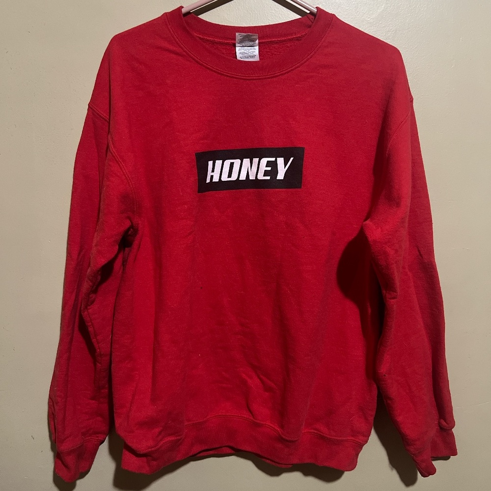 Red crewneck sweatshirt with black and white graphic